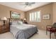 Comfortable bedroom with ceiling fan and a window with shutters at 16450 E Ave Of The Fountains -- # 23, Fountain Hills, AZ 85268
