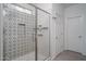 Clean shower with subway tile, geometric patterned tile, and glass enclosure at 17289 W Surrey Dr, Surprise, AZ 85388