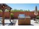 Outdoor kitchen area with built-in grill and pergola at 1807 W Sierra Sunset Trl, Phoenix, AZ 85085
