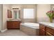 Elegant bathroom with double vanity, soaking tub, and glass block window at 1807 W Sierra Sunset Trl, Phoenix, AZ 85085