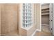Bathroom with shower, glass block feature wall, and linen closet at 1807 W Sierra Sunset Trl, Phoenix, AZ 85085