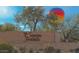 Sonoran Foothills community entrance with hot air balloon overhead at 1807 W Sierra Sunset Trl, Phoenix, AZ 85085
