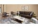 Cozy sitting area featuring a brown leather sofa and coffee table at 1807 W Sierra Sunset Trl, Phoenix, AZ 85085