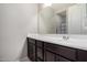 Simple bathroom with dark vanity and a single sink at 18254 W Via Montoya Dr, Surprise, AZ 85387