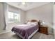 Well-lit bedroom with double bed, nightstand, and window at 18254 W Via Montoya Dr, Surprise, AZ 85387