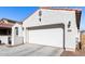 White two-car garage with driveway at 18254 W Via Montoya Dr, Surprise, AZ 85387