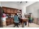 Home office with a desk, built-in shelves, and ample storage at 18254 W Via Montoya Dr, Surprise, AZ 85387