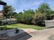 Landscaped yard featuring lush greenery, a stone birdbath, and a white picket fence at 2207 W Hayward Ave, Phoenix, AZ 85021