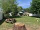 Large backyard featuring lush green grass, mature trees, and a wooden picnic table at 2207 W Hayward Ave, Phoenix, AZ 85021