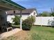 Inviting backyard featuring a covered patio, mature trees, green lawn, and a white fence at 2207 W Hayward Ave, Phoenix, AZ 85021