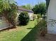 Backyard featuring green grass, privacy fence, mature trees and colorful plants at 2207 W Hayward Ave, Phoenix, AZ 85021
