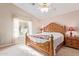 Spacious main bedroom with large wood bed frame and ensuite bathroom at 2207 W Hayward Ave, Phoenix, AZ 85021