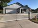 Inviting single-story home with a well-kept lawn, featuring a white picket fence and attached garage at 2207 W Hayward Ave, Phoenix, AZ 85021