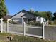 Charming single-story home featuring a white picket fence, manicured shrubs, and a well-maintained front yard at 2207 W Hayward Ave, Phoenix, AZ 85021