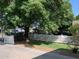Charming home featuring a lush tree, a well-kept lawn, and a classic white picket fence at 2207 W Hayward Ave, Phoenix, AZ 85021