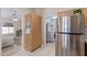 Kitchen features stainless steel refrigerator and access to laundry area at 2207 W Hayward Ave, Phoenix, AZ 85021