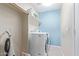 Bright laundry room with washer, dryer, and shelving at 2207 W Hayward Ave, Phoenix, AZ 85021