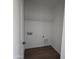 Simple laundry room with wood flooring and shelving at 22254 W Skinner Rd, Wittmann, AZ 85361