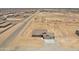 Aerial view of new home construction and its desert landscape in a neighborhood with paved roads at 22270 W Skinner Rd, Wittmann, AZ 85361