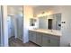 Bright bathroom featuring a double sink vanity, and a separate shower with glass doors at 22270 W Skinner Rd, Wittmann, AZ 85361