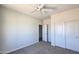 Neutral bedroom with carpet, ceiling fan, and double-door closet at 22270 W Skinner Rd, Wittmann, AZ 85361