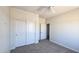 Neutral carpeted bedroom features a ceiling fan and a double-door closet at 22270 W Skinner Rd, Wittmann, AZ 85361