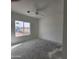 Bright bedroom with large window and ceiling fan at 22270 W Skinner Rd, Wittmann, AZ 85361
