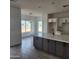 Modern kitchen with an island and view into dining area at 22270 W Skinner Rd, Wittmann, AZ 85361