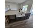 Kitchen island with a farmhouse sink and white quartz countertop at 22270 W Skinner Rd, Wittmann, AZ 85361