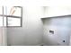 Empty laundry room has a window and hookups for a washer and dryer at 22270 W Skinner Rd, Wittmann, AZ 85361