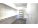 Walk-in closet featuring shelves, rods and carpet floors at 22270 W Skinner Rd, Wittmann, AZ 85361