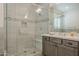 Bathroom with walk-in shower, pebble floor, and gray tile at 2480 E Haymore St, Gilbert, AZ 85298