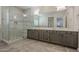 Modern bathroom with dual vanity, large shower, and grey tile floors at 2480 E Haymore St, Gilbert, AZ 85298