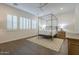 Elegant bedroom with canopy bed and hardwood floors at 2480 E Haymore St, Gilbert, AZ 85298