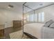 Spacious bedroom with wood floors, plantation shutters, and a four-poster bed at 2480 E Haymore St, Gilbert, AZ 85298