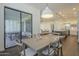 Kitchen and dining area with wooden table and access to backyard patio at 2480 E Haymore St, Gilbert, AZ 85298