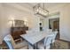 Bright dining room with marble table, chandelier, and views to other rooms at 2480 E Haymore St, Gilbert, AZ 85298