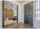 Bright entry with wood floors, built-in shelving, and a dark wood door at 2480 E Haymore St, Gilbert, AZ 85298