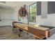 Game room showcasing a shuffleboard table and kitchen area at 2480 E Haymore St, Gilbert, AZ 85298