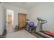 Spacious home gym with a treadmill, exercise bike, and weights at 2480 E Haymore St, Gilbert, AZ 85298