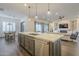 Open concept kitchen with island, stainless steel appliances, and hardwood floors at 2480 E Haymore St, Gilbert, AZ 85298