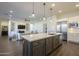 Open kitchen boasts a large island, stainless steel appliances, and ample counter space at 2480 E Haymore St, Gilbert, AZ 85298