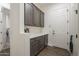 Laundry room with built-in cabinets and storage at 2480 E Haymore St, Gilbert, AZ 85298