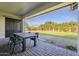 Covered patio with table and chairs, overlooking grassy backyard at 2480 E Haymore St, Gilbert, AZ 85298