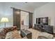 Relaxing sitting area, leather couch, barn doors, and TV at 2480 E Haymore St, Gilbert, AZ 85298
