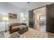 Comfortable sitting area with leather couch and view into dining area at 2480 E Haymore St, Gilbert, AZ 85298