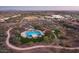 Aerial view of community pool and grounds, with winding sidewalk, lush landscaping and neighborhood at 30704 N 138Th Ave, Peoria, AZ 85383