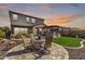 Spacious backyard with a stone patio, outdoor seating, and an outdoor kitchen for outdoor entertainment at 30704 N 138Th Ave, Peoria, AZ 85383