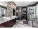 Modern bathroom featuring marble floors, stylish wallpaper, and sleek fixtures at 30704 N 138Th Ave, Peoria, AZ 85383