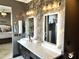 Modern bathroom with double vanity and a view into bedroom at 30704 N 138Th Ave, Peoria, AZ 85383